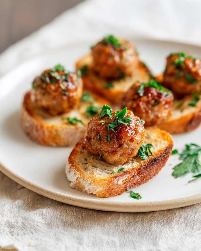 Juicy meatball appetizers on serving platter with sauces – party food ideas